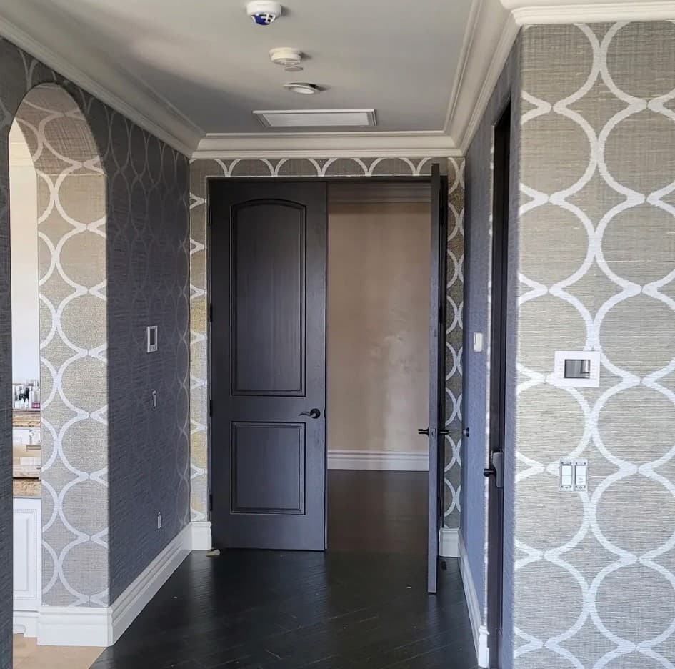 Hallway with bold geometric interlocking circle wallpaper pattern in dark gray