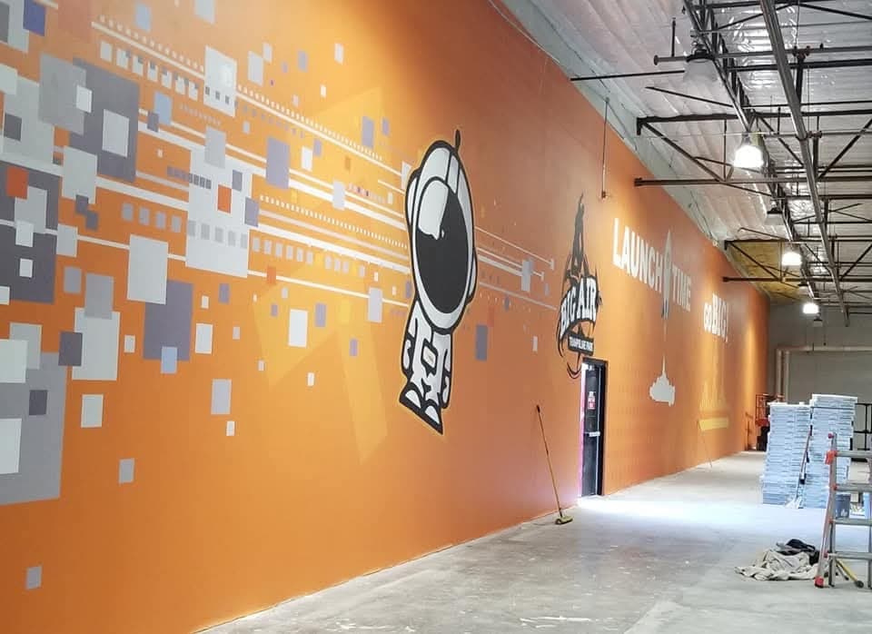 Wide-angle view of Big Air trampoline park commercial wall mural installation in Arizona