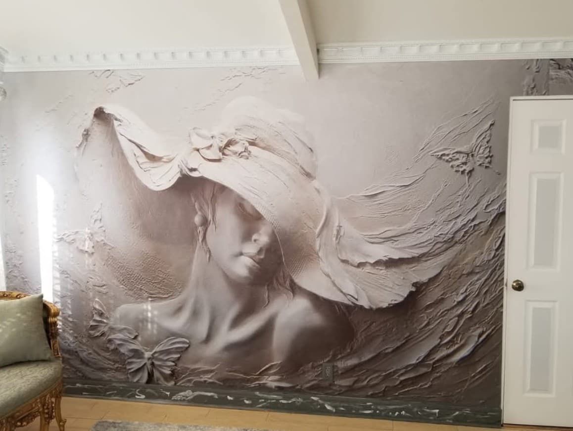 3D sculptural portrait mural wallpaper of a woman in a wide-brim hat installed in a luxury residential room