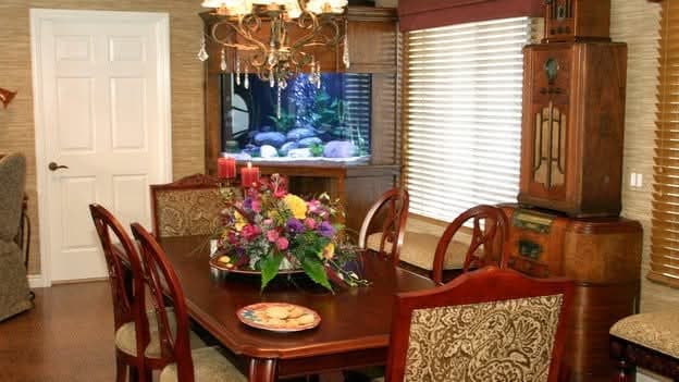 Elegant dining room with grasscloth wallpaper and chandelier featured on Extreme Makeover Home Edition TV show